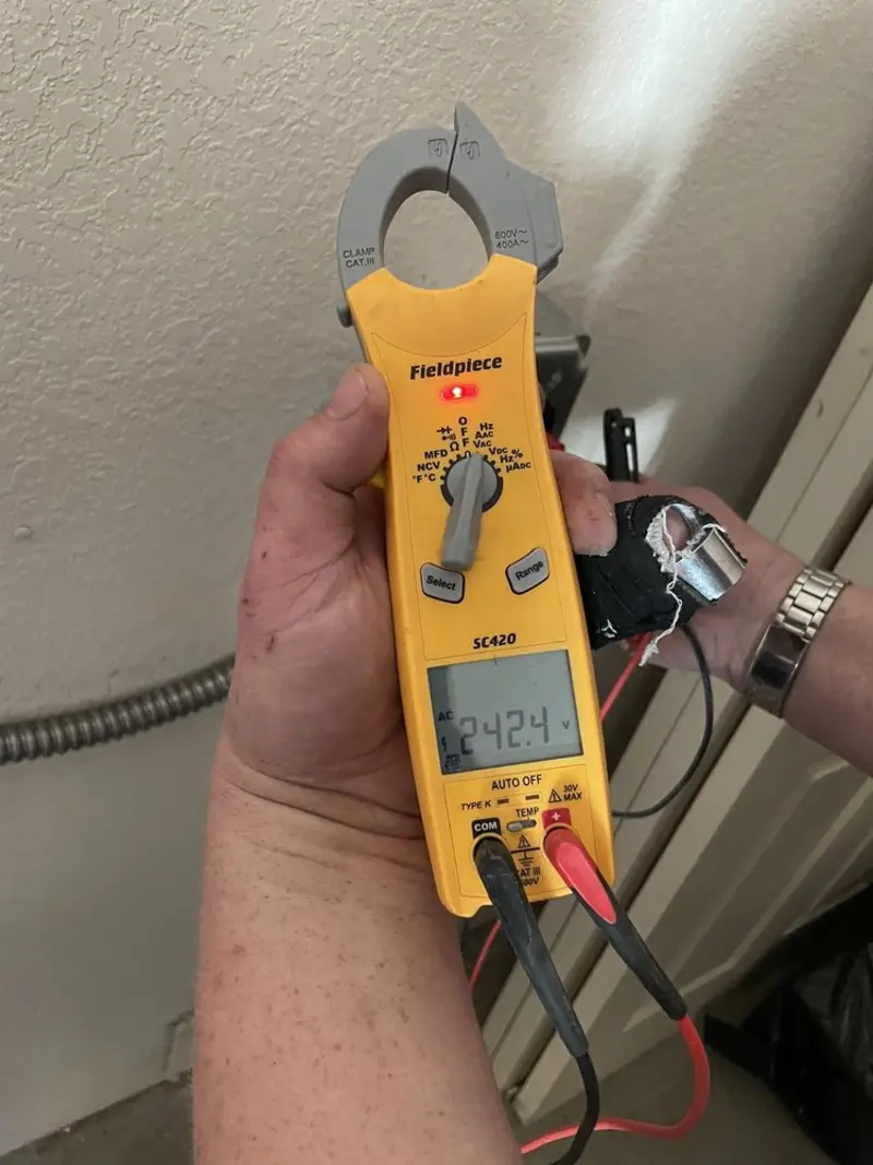 Voltage testing with clamp meter during Outlet Installation in Wolverine Lake